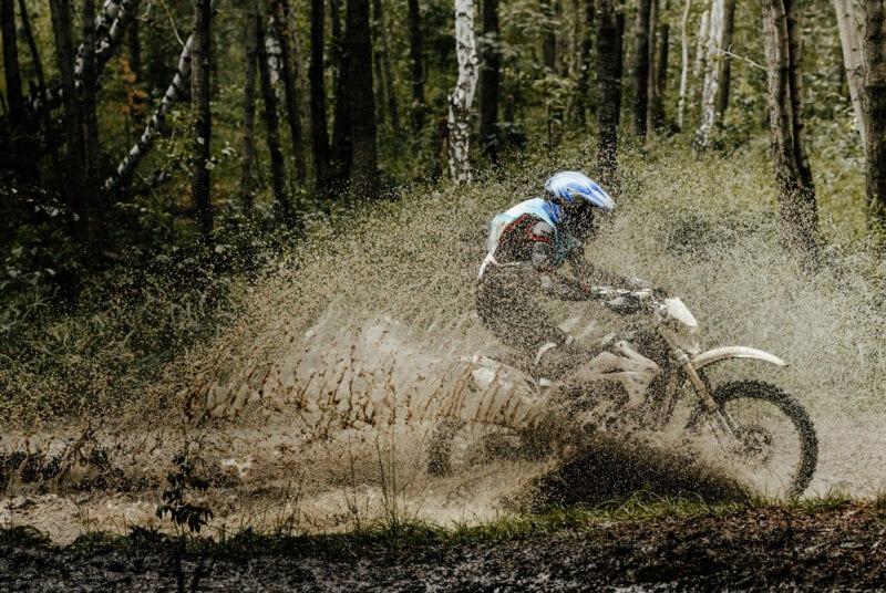 Off Road Motorbike in water driving fast in hard terrain.